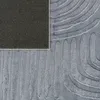 A close-up view of a rug with a geometric pattern and a textured surface. Produktbild-Vorschau