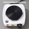 Close-up of a portable electric burner with a black coil heating element on a gray background. Produktbild-Vorschau