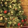 A close-up view of a decorated Christmas tree with lights and ornaments. Anteprima dell’immagine prodotto