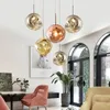 A collection of modern pendant lights hanging in a living room setting. Produktbild-Vorschau
