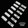 A collection of white plastic pleat mounting hardware and screws arranged on a black background. Produktbild-Vorschau