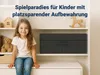 A young girl sits on a shelf in a room with toys and storage boxes. Produktbild-Vorschau