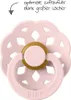 A pink pacifier with a gold ring, set against a white background. Text in the upper left corner describes optimal airflow due to large holes. Produktbild-Vorschau