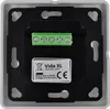 The back of a white electrical wall plate with a black mounting bracket and a green terminal block. A label with product information is visible. Náhled obrázku produktu