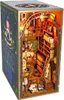 A miniature 3D model of a magical library or study, designed to fit between books on a shelf. Voir les images du produit