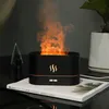 A black humidifier with a flame effect sits on a book next to a small decorative tree and a potted plant. Voir les images du produit