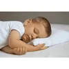 A young child sleeping peacefully on a white pillow. Produktbild-Vorschau