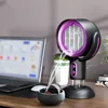 A portable fan and air purifier is shown on a desk next to a laptop, with steam rising from a small bowl in front of it. Produktbild-Vorschau