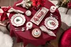 A Christmas-themed table setting with plates, mugs, and decorations. Náhled obrázku produktu