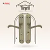 A pair of antique-style door handles displayed against a decorative background with architectural elements. Produktbild-Vorschau