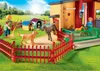 A Playmobil playset depicting a dog hotel with figures and dogs in an outdoor setting. Produktbild-Vorschau