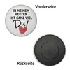 A round magnet with text and a heart on the front, and a magnetic backing on the reverse. Produktbild-Vorschau