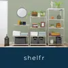 Three metal shelving units are displayed in a room with a light green wall, showcasing various items like towels, baskets, books, and decorative objects. Podgląd zdjęcia produktu