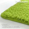 A close-up, angled view of a fluffy green rug with text overlays. Anteprima dell’immagine prodotto