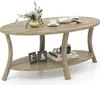 An oval-shaped coffee table with a lower shelf, decorated with a vase of flowers, a cup of coffee, a book, picture frames, and a camera. Produktbild-Vorschau