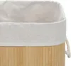 Close-up view of the top edge of a bamboo laundry basket with a fabric liner and rope handle. Podgląd zdjęcia produktu