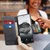 A person is using a phone with a wallet case to make a payment at a terminal. Produktbild-Vorschau