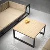 A modern outdoor seating area with a couch and coffee table. Produktbild-Vorschau