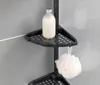 A close-up of a black corner shower caddy with a bottle of lotion and a loofah. Náhled obrázku produktu