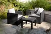 Outdoor seating area with chairs and a table on a patio, surrounded by greenery. Produktbild-Vorschau