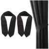 Two black tie-backs for curtains are shown against a white background, with a black curtain in the background. Produktbild-Vorschau