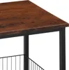 Close-up of a wooden table top with black metal legs and a wire basket. Náhled obrázku produktu