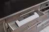 A white vacuum sealer is stored in an open kitchen drawer. Anteprima dell’immagine prodotto