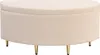 A beige upholstered storage ottoman with gold metal legs is shown against a white background. Produktbild-Vorschau