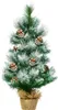 A small, artificial Christmas tree decorated with pinecones and artificial snow, standing in a burlap pot. Náhled obrázku produktu