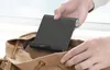 A person is placing a black Ugreen desk stand into a brown canvas bag. Náhľad obrázku produktu