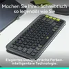 A close-up shot of a keyboard on a desk, with a laptop in the background. Náhľad obrázku produktu