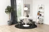 A dining room setting with a round white table, four chairs, a plant, and a bookshelf. Voir les images du produit