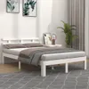 A white wooden bed frame with pillows and a blanket in a bedroom setting. Produktbild-Vorschau