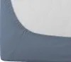 A close-up view of a blue fitted sheet on a mattress. Produktbild-Vorschau