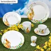 Easter-themed tableware set arranged on a grassy surface with yellow flowers. Náhled obrázku produktu