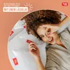 A woman is lying on pillows, holding one up to her eye playfully, with marketing text and a logo in the background. Produktbild-Vorschau