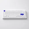 A white mechanical keyboard with blue accent keys is shown on a plain white and light gray background. Voir les images du produit
