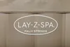 A close-up view of the Lay-Z-Spa Palm Springs logo on a tan textured surface. Produktbild-Vorschau