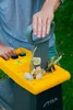 A person is using a garden shredder to shred leaves and twigs. Produktbild-Vorschau