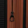 A close-up view of a black zipper pull on a brown suitcase. Podgląd zdjęcia produktu