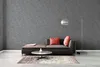 A modern living room scene with a sofa, coffee table, rug, and floor lamp. Produktbild-Vorschau