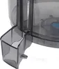 A close-up view of a gray plastic attachment with a small blue component visible inside a larger transparent container. Produktbild-Vorschau