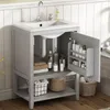 A bathroom vanity with a sink and storage, featuring an open cabinet door revealing shelves with toiletries. Voir les images du produit