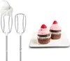 A side-by-side image showing two parts of a hand mixer and two finished cupcakes. Produktbild-Vorschau