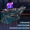 A gaming desk setup with a computer, chair, and accessories, set against a city skyline at night. Voir les images du produit