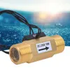 A brass flow sensor with wires and a label, set against a blurred blue background resembling water. Produktbild-Vorschau