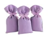 Three lavender-colored fabric sachets tied with a ribbon, arranged in a row against a white background. Produktbild-Vorschau