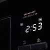 A close-up view of a digital display on a black appliance, showing time and function icons. Anteprima dell’immagine prodotto