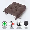 A brown seat cushion is shown from a diagonal angle, with four circular icons below it illustrating its features. Náhled obrázku produktu