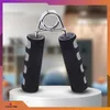 A hand grip exerciser is displayed on a white pedestal against a blurred background. Podgląd zdjęcia produktu